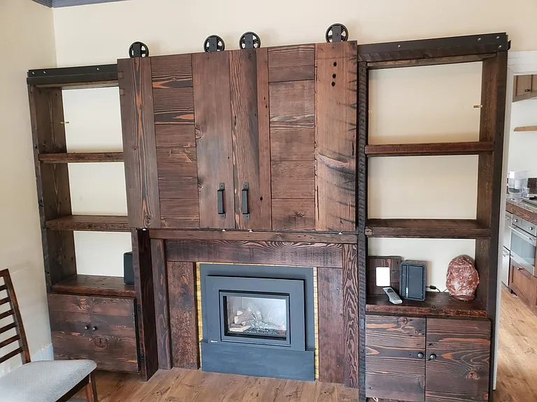 Living Room Built In Cabinetry that Hides TV and shows book-cases