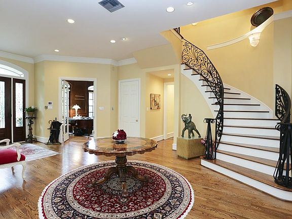 Gracious curved stair case and 11ft ceilings down, create the perfect spot to entertain .Special features:Hardwoods,art nooks&lighting,elevator to all 3 levels,under stair storage,and large coat closet.