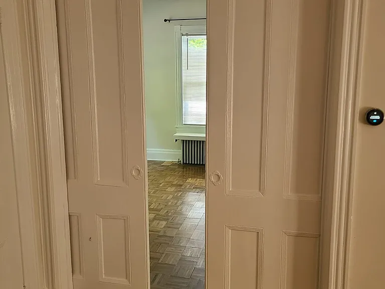 Pocket doors lead to first bedroom.