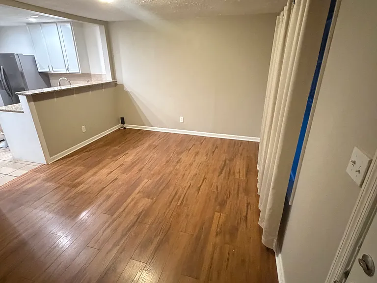 Front door looking into living room and kitchen