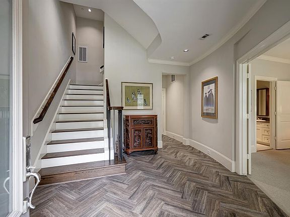 The spacious entry features woodgrain tile flooring and an oversized closet/elevator shaft.