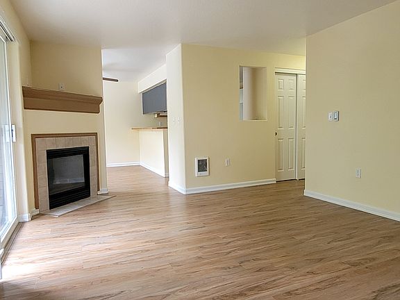 Living room view of Fireplace, eating area and closet in hallway