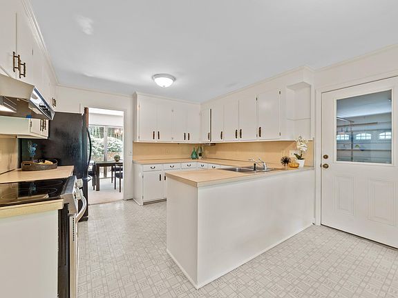 Kitchen is upgraded with new dishwasher and range.