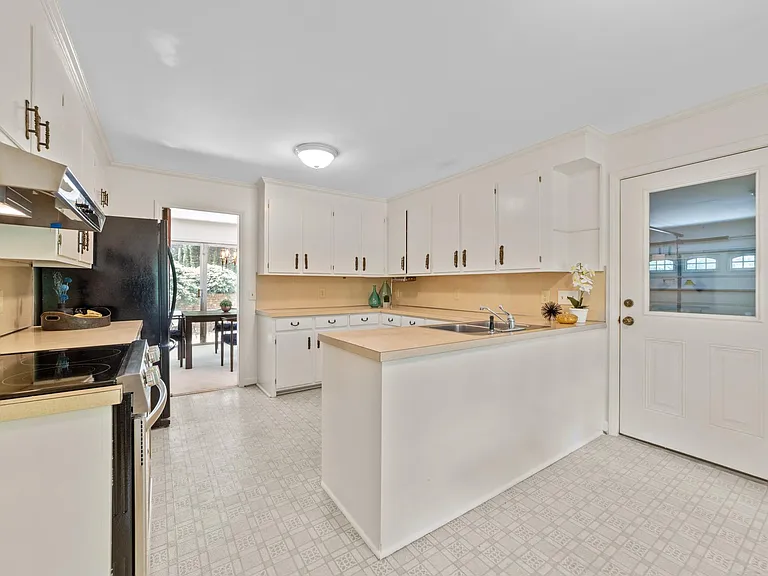 Kitchen is upgraded with new dishwasher and range.