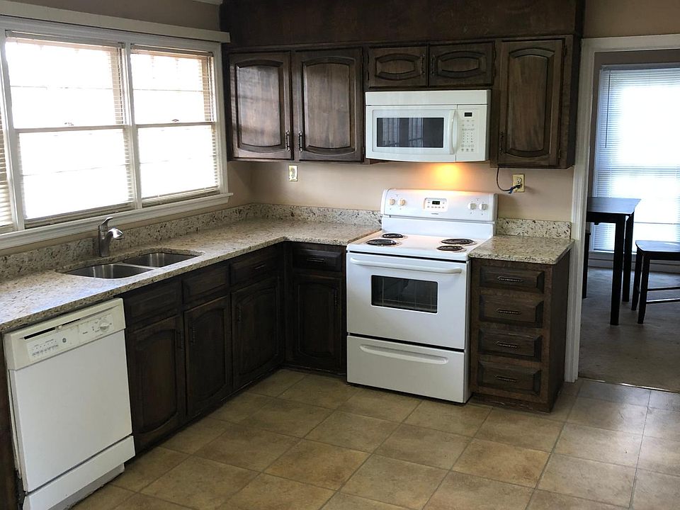 Kitchen with new granite counters and stainless sink-refinished cabinets/drawers-stove-dishwasher-refrigerator-new microwave-pantry.