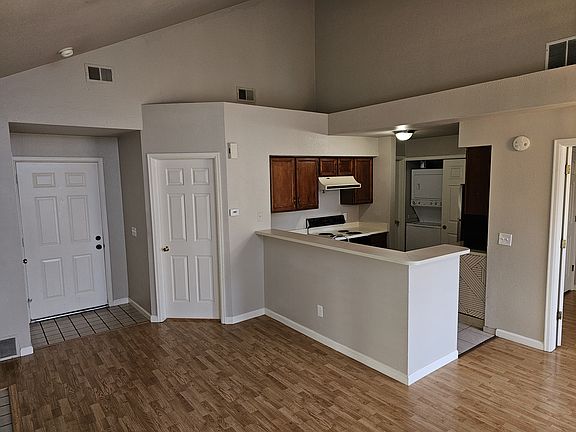 Entry Door to the condo, kitchen, washer/dryer storage