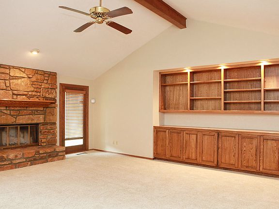 Large Great Room with wall of built-ins and an oversized stone fireplace