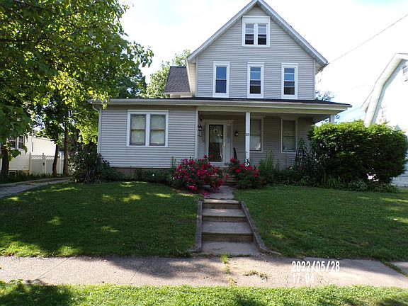 Rose bushes adorn the front sidewalk