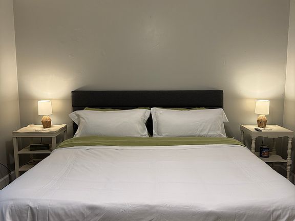 King bedroom with closet, desk, and smart tv.