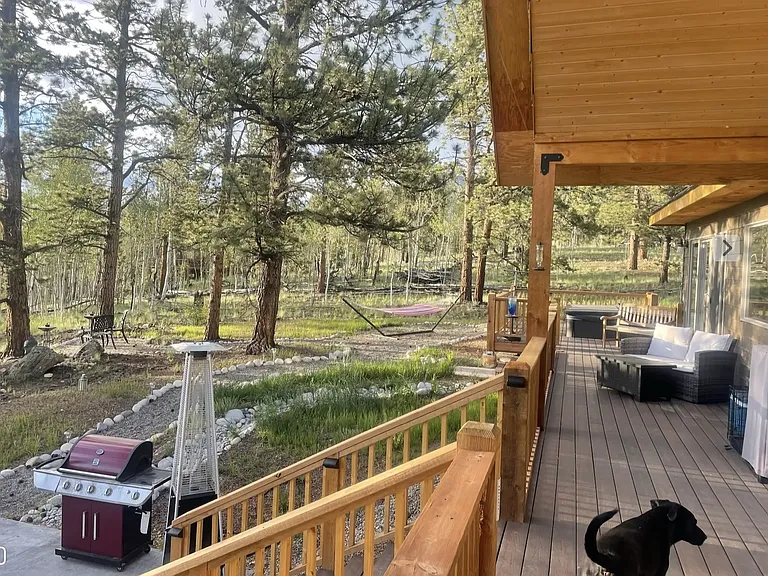 large back deck that wraps around hot tub & stairs down to dining patio
