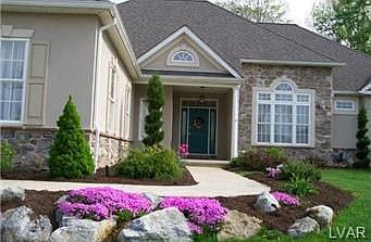 Partial stone front - concrete walk to covered front porch