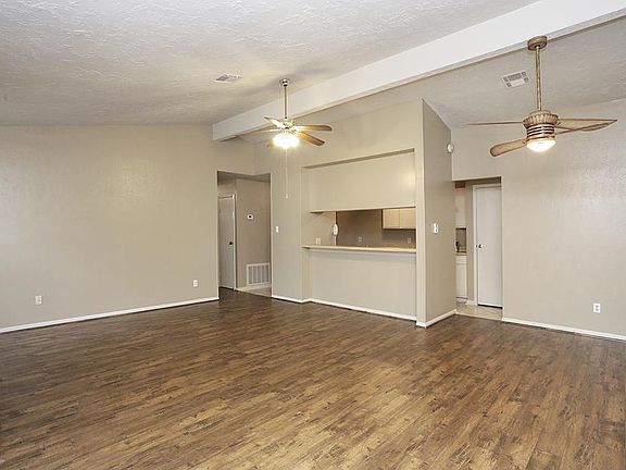 LARGE OPEN FAMILY ROOM WITH HIGH CEILINGS & LAMINATE WOOD FLOORING ~