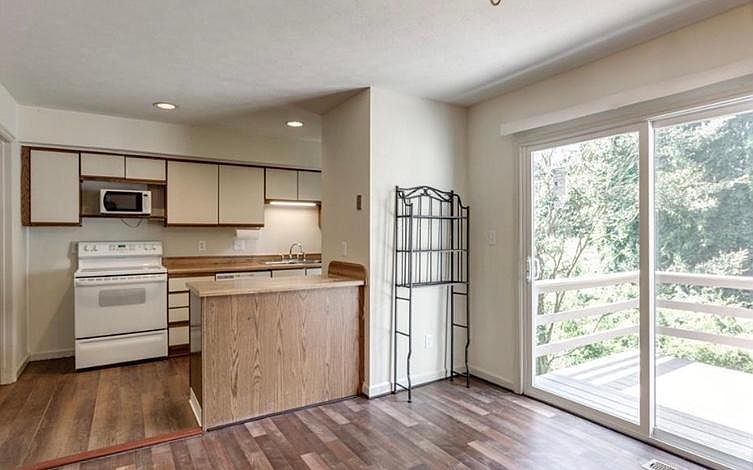 The kitchen features a dishwasher, new microwave (not pictured), stove, refrigerator, large pantry, and a washer/dryer in a laundry room just off the kitchen.