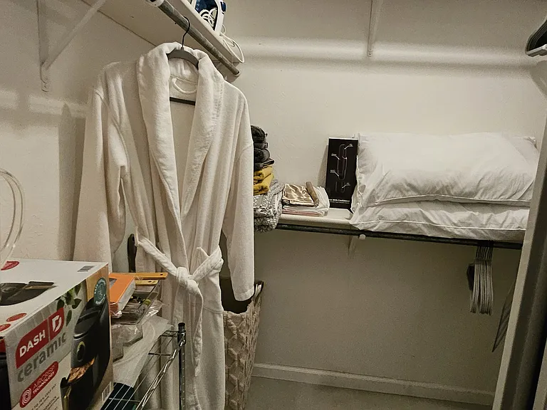 Large Walk-in closet with shoe rack and other numerous amenities.