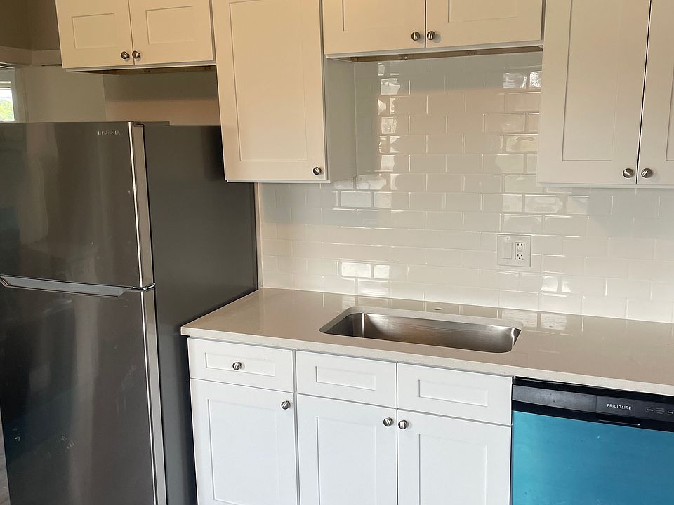 Kitchen comes complete with subway tile backsplash and new appliances, including dishwasher (note that the blue is protective wrapping from original packaging)