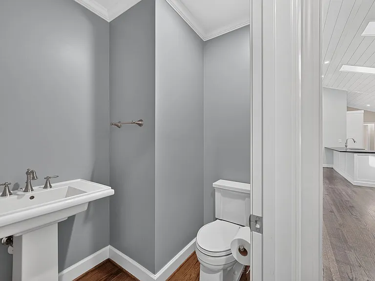 Guest powder room off of family room. Tenants can add their favorite mirror to personalize the space.