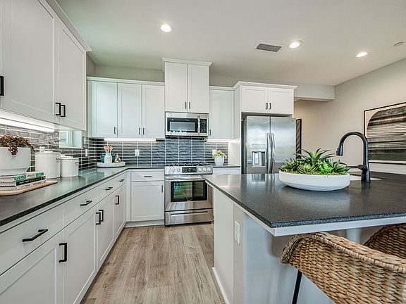 Kitchen features extensive wraparound countertops plenty of cabinetry for easy cooking storage