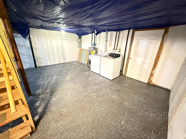 Freshly painted basement with washer and dryer