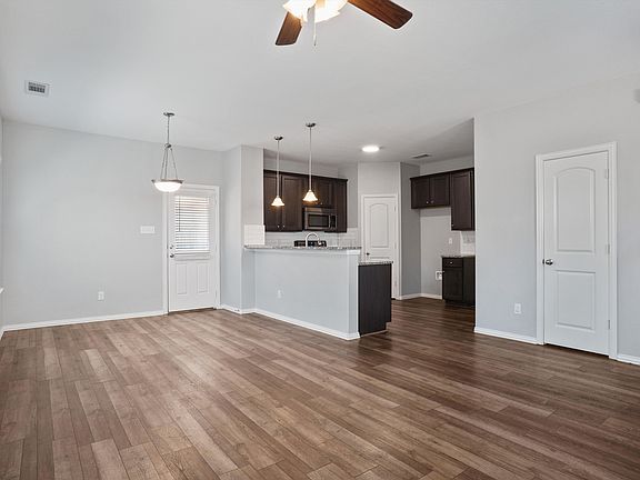 Dining and Kitchen. Door to right is a Half Bathroom.