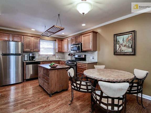 Eat-in custom kitchen with all stainless steel appliances.