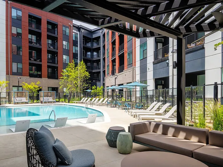 Resort-style pool and sundeck with cabanas and shaded lounge areas