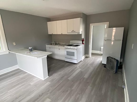 Kitchen far view, living area on other side.