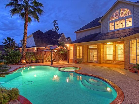 Evening Photo Of Pool/Spa/Waterfall and Rear Of Home