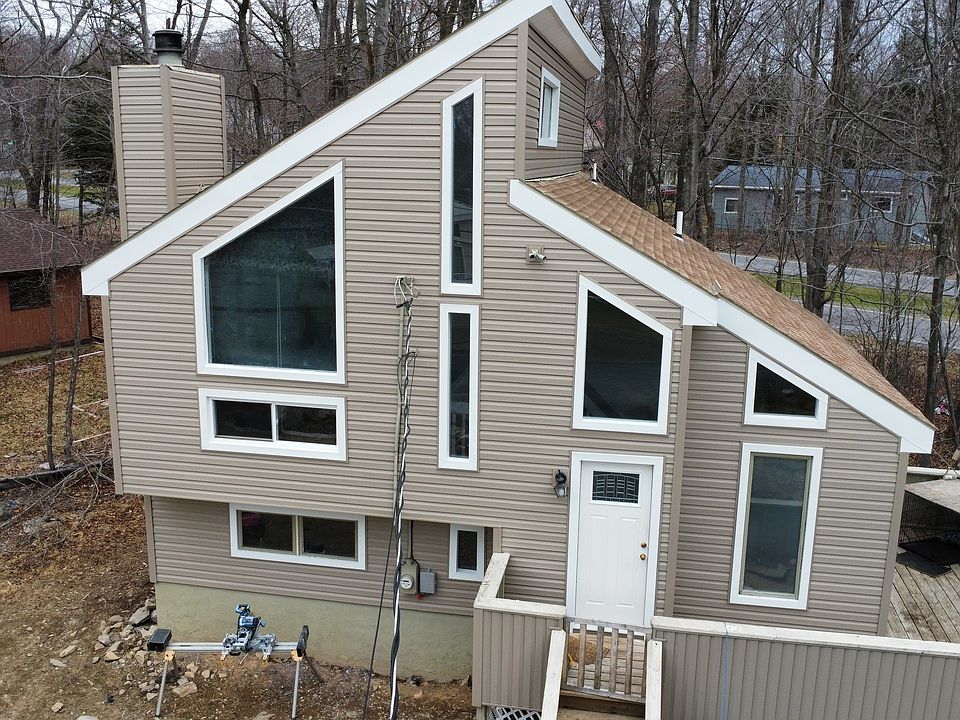 Front Elevation with New Siding, front door, and several new windows