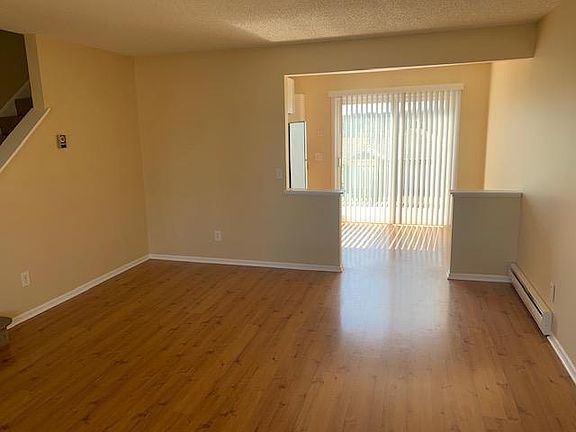 Living room toward kitchen and deck.