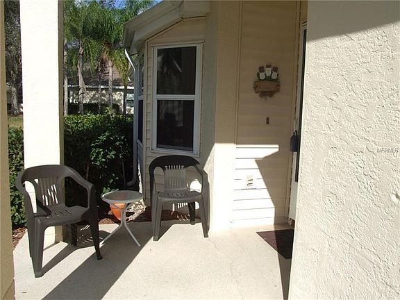 SIDE ENTRANCE WITH SCREEN DOOR AT ENTRY.