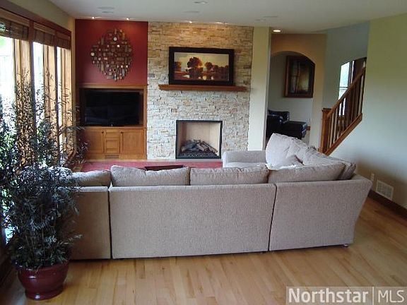 Main floor great room with informal eating space with sliders to deck. Second stair case removed for more room space added to the main floor. New built in audio/visual system and cabinet. New zero clearance fireplace with REAL stone and Cherry mantle