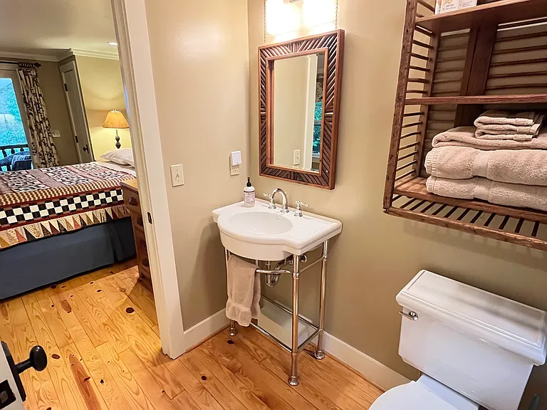 Bathroom with bright lighting and soft linens.
