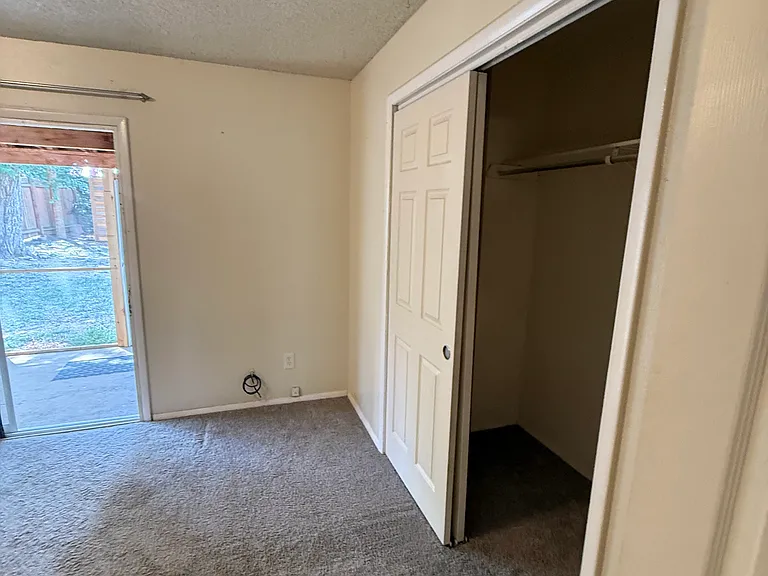 Master Bedroom with attached bathroom. Walks out to fenced yard, has private access from side & its own screened in patio.