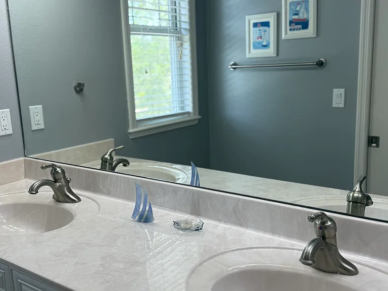 Second full bath with dual sinks and pocket door to shower and toilet