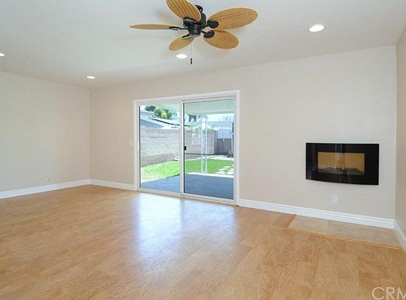 Light & bright living room with fireplace and slider to rear patio