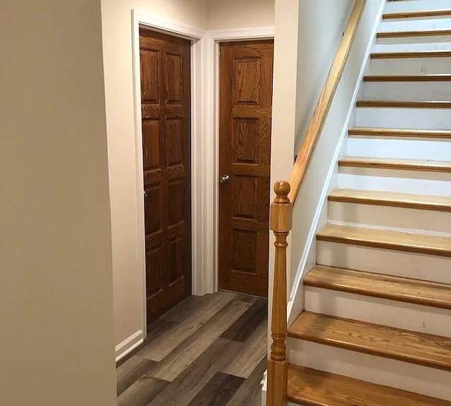 stairs and doorway to front bedroom and interior bedroom