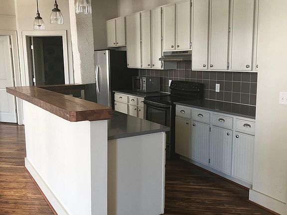 Kitchen with stainless appliances and new Silestone quartz countertops.