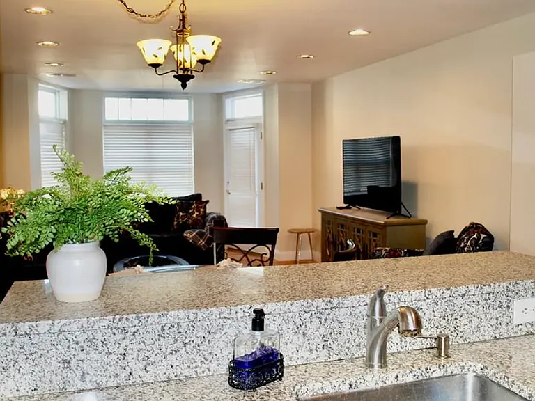 Modern kitchen with stainless steel appliances, including a new refrigerator. Granite counter tops.
