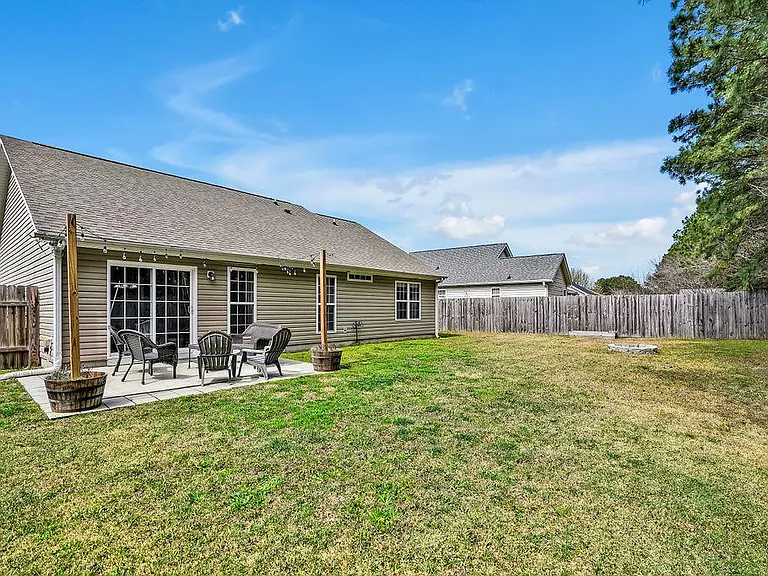 Privacy fenced in backyard and patio. Flower pots with posts and sting lights included.
