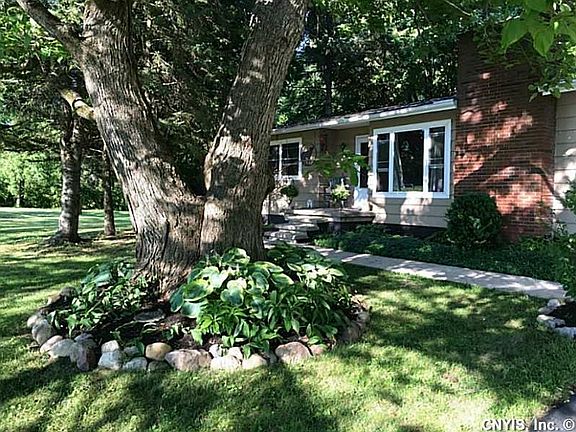 Exterior Front. Just under one full acre, property has lots of shade trees and low maintenance landscaping.