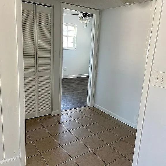 Hallway to bedrooms and linen closet