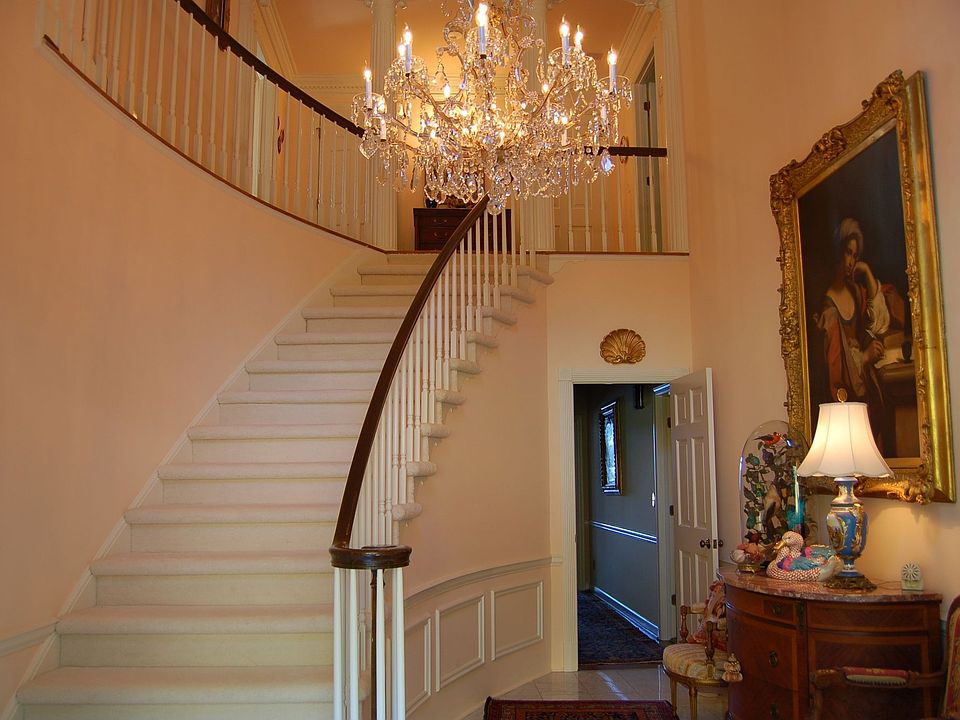 Two Story Foyer with Circular Staircase and Marble Floor