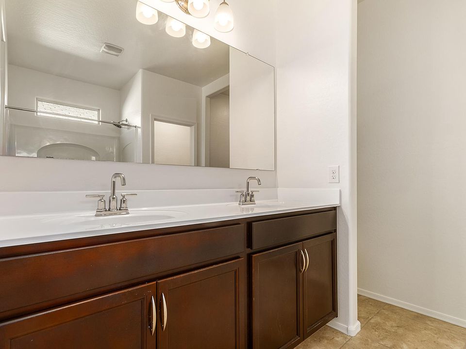 Large Master bathroom with double sink and plenty of lighting.