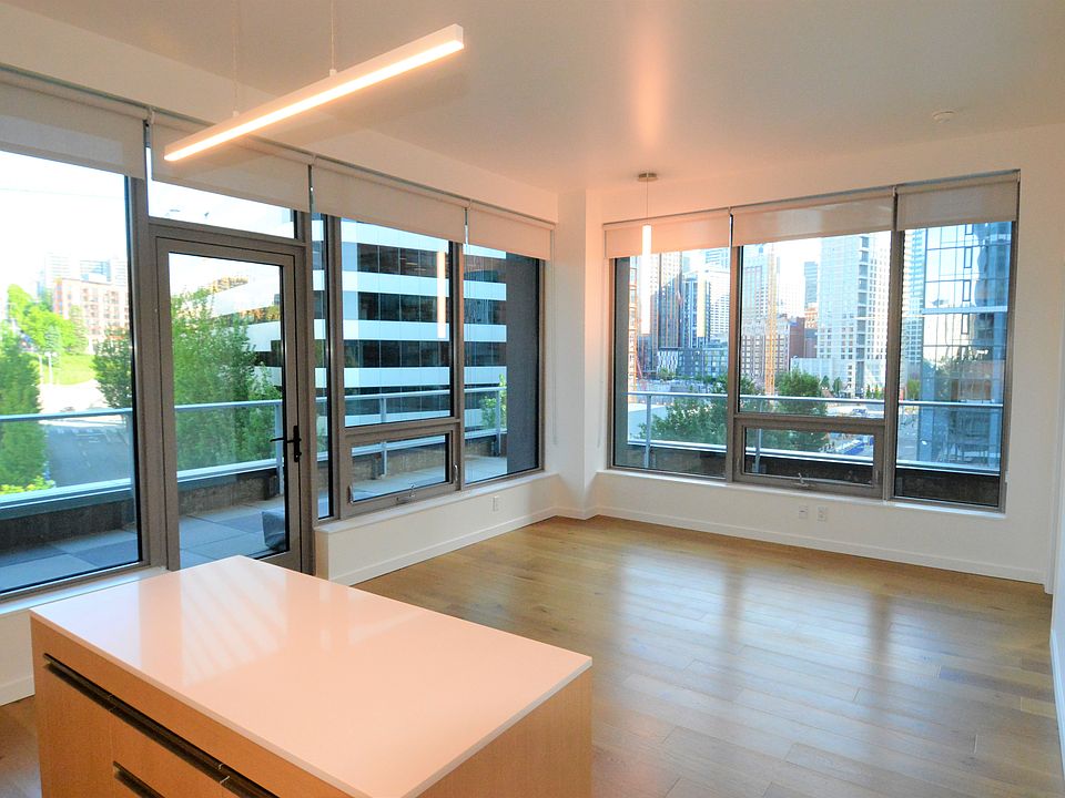 View from Kitchen area looking thru the living room, (southerly exposure) to Unit 700s private exterior deck areas.