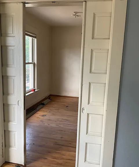 Front rooms connected by pocket doors--now has new windows, new lights, new white paint