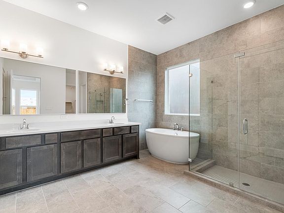 Primary bath with standalone tub and glass shower