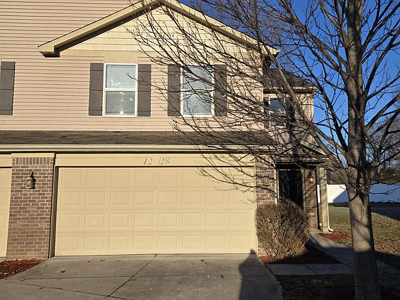 Frontal view with front door and garage
