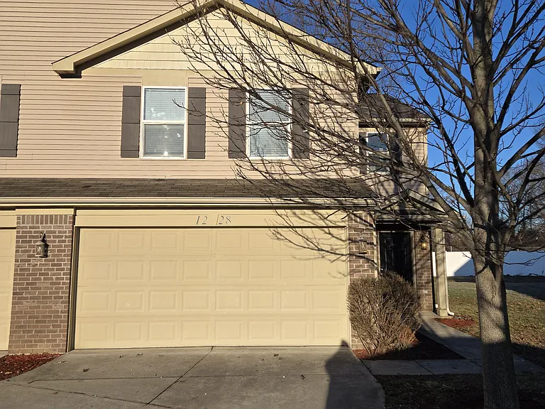 Frontal view with front door and garage