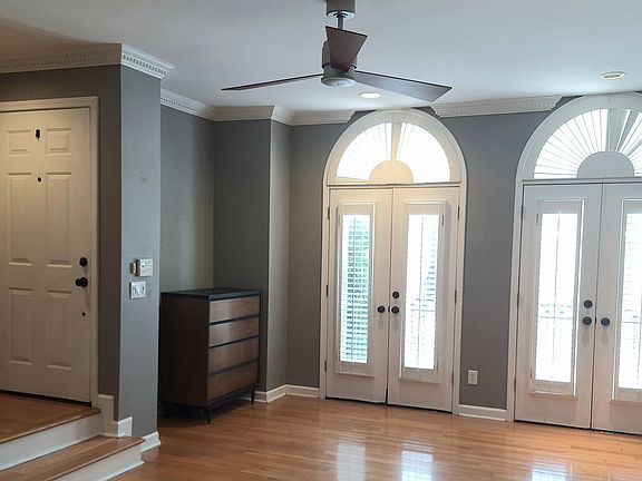 Main floor living room and front entry with steps to third floor.