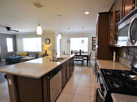 Staged kitchen, dining area, and living room (furnishings not included)